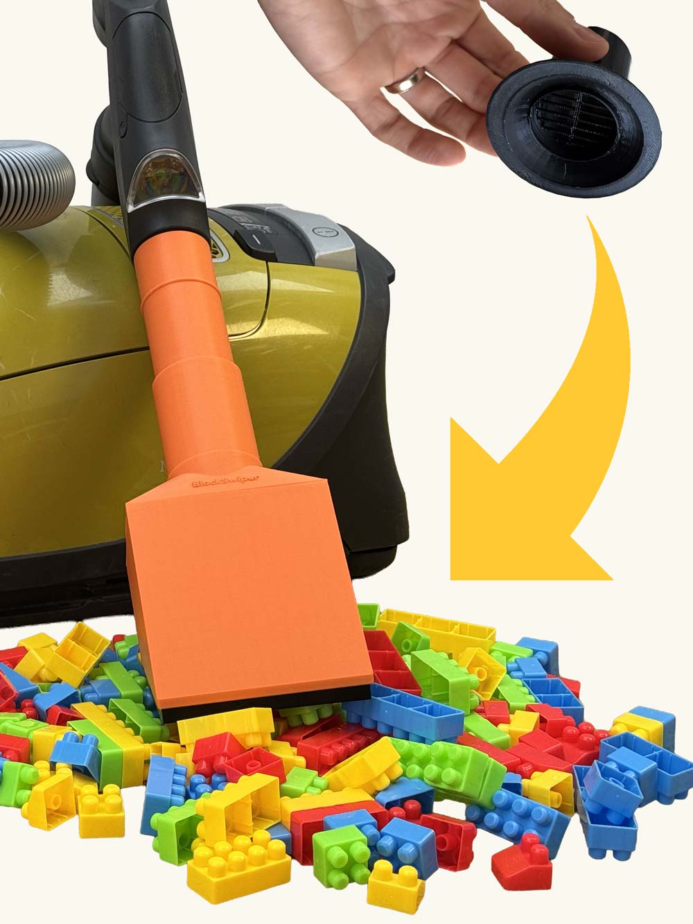 BlockSwiper vacuum cleaner attachment being used to clean colorful building blocks